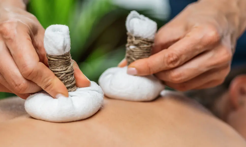 Ayurvedic spa in Coimbatore with herbal pouch massage therapy on back